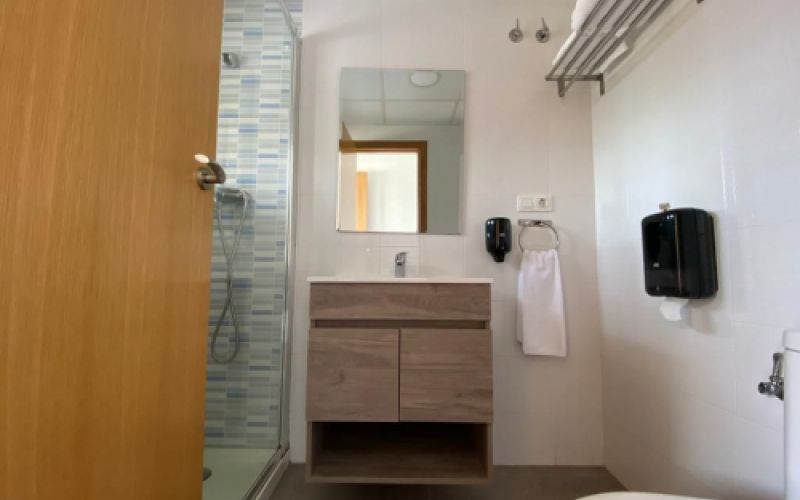 Imagen del baño de una de las habitaciones con diseño moderno en tonos claros